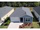 New home featuring a well-maintained yard, an attached one-car garage, and a neutral grey color palette at 3437 Possehl Pl, The Villages, FL 32163