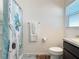 The bathroom features a vanity, toilet, and shower/tub with a blue floral shower curtain at 3437 Possehl Pl, The Villages, FL 32163