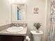 Comfortable bathroom featuring granite countertop, white toilet and decor at 3437 Possehl Pl, The Villages, FL 32163