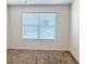 Bright bedroom with neutral carpet and a window offering natural light at 3437 Possehl Pl, The Villages, FL 32163