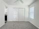 The bedroom is bright and airy with a large closet and neutral colored walls at 3437 Possehl Pl, The Villages, FL 32163