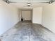 View of the open garage with a concrete floor and an automatic garage door opener; ideal for parking and storage at 3437 Possehl Pl, The Villages, FL 32163