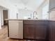 A modern kitchen offers stainless appliances, and an island open to the living area at 3437 Possehl Pl, The Villages, FL 32163