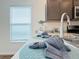 The kitchen includes a stainless sink, countertops, and decor for a homey feel at 3437 Possehl Pl, The Villages, FL 32163