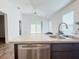 A modern kitchen featuring a stainless steel dishwasher and double sink at 3437 Possehl Pl, The Villages, FL 32163