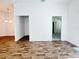 Open living room with wood-style flooring and doorways leading to other rooms at 3437 Possehl Pl, The Villages, FL 32163