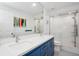 Modern bathroom with a double vanity, a large mirror, and a glass-enclosed shower, creating a spa-like experience at 3616 Deer Oak Cir, Oviedo, FL 32766