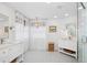 Bright, all-white bathroom with dual vanities, patterned floors, and luxurious finishes at 3616 Deer Oak Cir, Oviedo, FL 32766