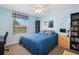 Bright bedroom with blue walls, a comfortable bed, and window view, complemented by a dresser and shelving units at 3616 Deer Oak Cir, Oviedo, FL 32766