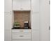 Close up on elegant coffee bar with white cabinetry, dark countertop, and stylish tile backsplash at 3616 Deer Oak Cir, Oviedo, FL 32766