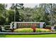 Stone entrance sign with beautiful landscaping at Live Oak Reserve community at 3616 Deer Oak Cir, Oviedo, FL 32766