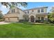 Two-story home featuring a three-car garage and a well-maintained front lawn at 3616 Deer Oak Cir, Oviedo, FL 32766