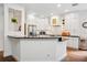 Open-concept kitchen featuring white cabinets, dark countertops, and a breakfast bar for casual dining at 3616 Deer Oak Cir, Oviedo, FL 32766