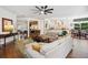 Living area features hardwood floors, furniture, and access to the kitchen and dining room at 3616 Deer Oak Cir, Oviedo, FL 32766