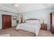 Spacious main bedroom featuring tray ceilings, soft carpet, and wooden furnishings at 3616 Deer Oak Cir, Oviedo, FL 32766