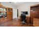 Bright office with wood cabinets, desk, and wood-look floors at 3616 Deer Oak Cir, Oviedo, FL 32766