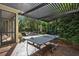 Relaxing outdoor patio featuring a pergola, lush landscaping, and a fun ping pong table at 3616 Deer Oak Cir, Oviedo, FL 32766