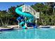 Community pool featuring a winding water slide for hours of fun at 3616 Deer Oak Cir, Oviedo, FL 32766
