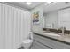 Bathroom featuring granite counters, a vessel sink, and a shower with a curtain at 3801 S Atlantic Ave # 114, New Smyrna Beach, FL 32169