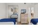 Shared bedroom featuring twin beds, coordinated decor, and a mirrored closet at 3801 S Atlantic Ave # 114, New Smyrna Beach, FL 32169
