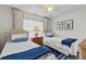 Comfortable bedroom with twin beds, white linens, and classic coastal decor at 3801 S Atlantic Ave # 114, New Smyrna Beach, FL 32169