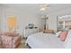 Bright bedroom featuring a comfortable bed, dresser, and access to a private balcony at 3801 S Atlantic Ave # 114, New Smyrna Beach, FL 32169