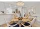Open-concept dining area with a round table, seating for four, and stylish decor at 3801 S Atlantic Ave # 114, New Smyrna Beach, FL 32169