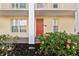 Charming condo entrance with vibrant flowers and inviting curb appeal at 3801 S Atlantic Ave # 114, New Smyrna Beach, FL 32169