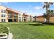 Well-maintained lawn area bordered by multiple buildings and green landscaping at 3801 S Atlantic Ave # 114, New Smyrna Beach, FL 32169