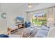 Bright living room featuring stylish furnishings, tv, and a sliding glass door to the patio at 3801 S Atlantic Ave # 114, New Smyrna Beach, FL 32169