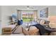 Bright living room with comfortable seating and a sliding glass door to the patio at 3801 S Atlantic Ave # 114, New Smyrna Beach, FL 32169