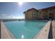 Beautiful pool at building with ocean views and ample lounge chairs at 3801 S Atlantic Ave # 114, New Smyrna Beach, FL 32169