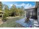 Charming backyard patio with a blue patterned rug and views of the lush green yard at 3893 Wind Dancer Cir, St Cloud, FL 34772