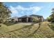 Spacious backyard featuring a screen in lanai, and verdant lawn at 3893 Wind Dancer Cir, St Cloud, FL 34772