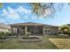 Large backyard featuring a screened-in lanai, gardening beds and a verdant lawn at 3893 Wind Dancer Cir, St Cloud, FL 34772
