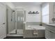 Bright bathroom featuring a soaking tub, glass enclosed shower, floating shelves and modern finishes at 3893 Wind Dancer Cir, St Cloud, FL 34772