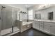Bright bathroom featuring a soaking tub, glass enclosed shower and double vanity with a large mirror at 3893 Wind Dancer Cir, St Cloud, FL 34772