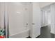 Bathroom featuring a bathtub with white tiles, a shower, and a view of the hallway at 3893 Wind Dancer Cir, St Cloud, FL 34772