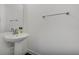 Close-up of a simple pedestal sink in a half bathroom with silver fixtures and neutral walls at 3893 Wind Dancer Cir, St Cloud, FL 34772