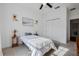 Bright bedroom featuring a large window with white curtains, wall decor, and closet at 3893 Wind Dancer Cir, St Cloud, FL 34772