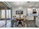 Dining area with a round table and chairs next to sliding glass doors and a view of the kitchen at 3893 Wind Dancer Cir, St Cloud, FL 34772