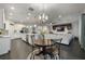 Open concept kitchen and dining area with a modern chandelier and a view of the living area at 3893 Wind Dancer Cir, St Cloud, FL 34772