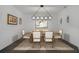 Elegant dining room with a rustic wood table and modern chandelier at 3893 Wind Dancer Cir, St Cloud, FL 34772