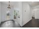 Inviting entryway with dark wood flooring, a clear view into the bright living room and hallway at 3893 Wind Dancer Cir, St Cloud, FL 34772