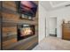 Modern fireplace feature wall with a mounted TV and a small decorative shelf at 3893 Wind Dancer Cir, St Cloud, FL 34772