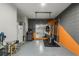 Residential garage showing an elliptical bicycle, refrigerator and painted walls at 3893 Wind Dancer Cir, St Cloud, FL 34772