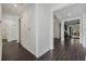 Bright hallway with wood-look tile flooring leading to the living areas at 3893 Wind Dancer Cir, St Cloud, FL 34772
