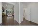 Hallway view into the living room and an adjacent half bathroom with tile flooring at 3893 Wind Dancer Cir, St Cloud, FL 34772