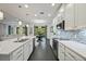 Bright kitchen features white cabinets, quartz countertops, a mosaic backsplash, and stainless steel appliances at 3893 Wind Dancer Cir, St Cloud, FL 34772