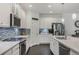 Stunning kitchen features white cabinets, quartz countertops, stainless appliances, and a tiled backsplash at 3893 Wind Dancer Cir, St Cloud, FL 34772